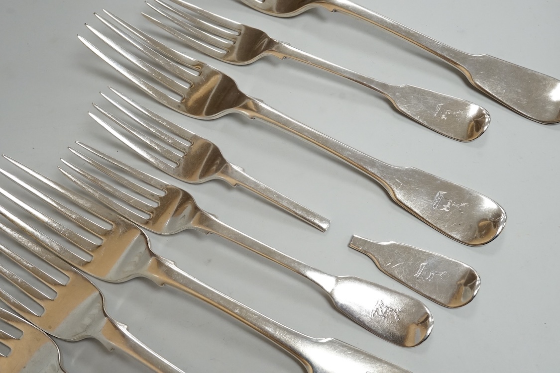 A set of six late George III silver fiddle pattern table forks, Thomas Wilkes Barker, London, 1818, together with five 19th century assorted silver fiddle pattern dessert forks, one broken in half, 18.8oz.